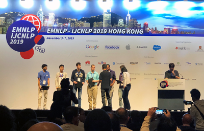 People on stage receiving an award