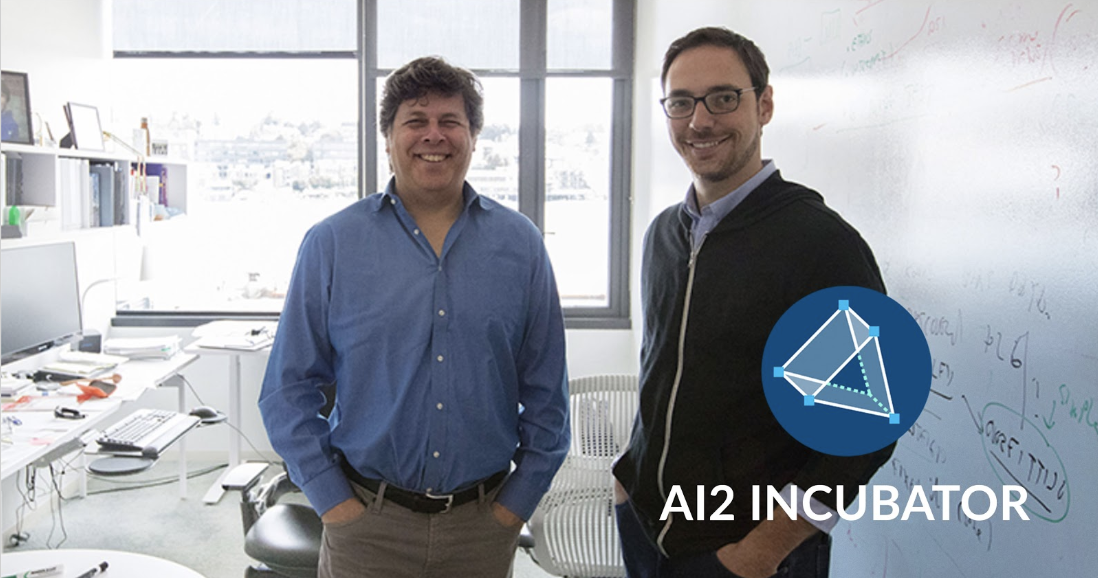 Oren and Jacob smiling with their hands in their pockets