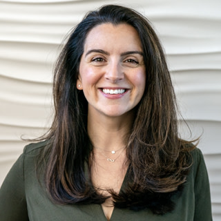 A photograph of Yejin Choi, a woman with long brown hair wearing a dark green shirt.